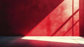 Minimalist red wall with light and shadow creating geometric patterns. Simple composition with graphic appeal and contrast. photo