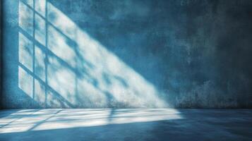 Blue textured wall with light casting shadows in a bare room. A place for quiet contemplation or visual representation of mood. photo