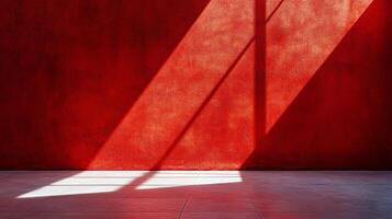 Red wall with sunlight creating a dramatic shadow pattern. Minimalist aesthetic highlighting texture, color, and light interplay. photo