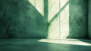 A serene image of window light casting geometric shadows on an aged, green wall and floor creating a contemplative space. photo