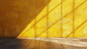 A bright yellow wall and wooden floor are illuminated by the patterned shadows of sunlight streaming in from an unseen window. photo