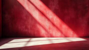 A minimalist composition showcasing a vibrant red wall intersected by striking diagonal beams of light, creating a visually compelling contrast. photo