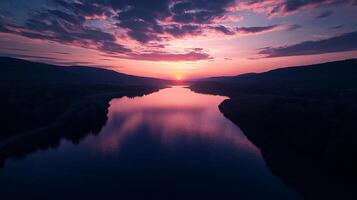 Vibrant sunset over a tranquil river, reflecting the colorful sky in its calm waters. A picturesque scene of nature's beauty. photo