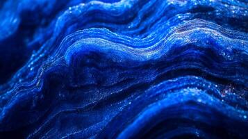 Intricate blue waves, shimmering with light, evoke a sense of depth and fluidity, capturing nature's artistry in an abstract form. photo