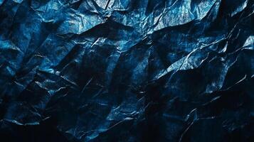 Abstract blue and black background showcasing crumpled texture, creating depth and visual intrigue. Modern, artistic surface with light. photo