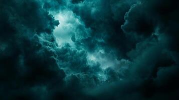 Dramatic teal clouds loom, illuminated from within, creating a sense of awe and impending weather in the dark, moody sky formation. photo