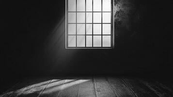 Rays of sunlight filter through a window in a darkened room. A single light source provides stark contrast to the dim interior. photo