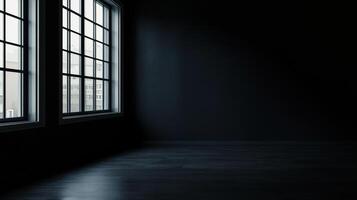 Dark room illuminated by natural light streaming through tall windows, casting shadows on the floor creating a minimalist aesthetic. photo