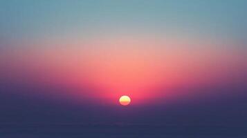 Sun setting below horizon creating pink and purple gradient in sky photo