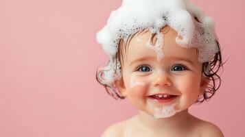 A charming baby with bubbly foam adorning their head, smiles brightly against a soft pink backdrop, radiating pure joy and innocence. photo