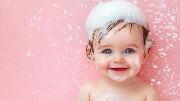 Adorable baby smiles brightly in a pink tub with bubbles on its head, joyfully enjoying bath time and creating a heartwarming scene. photo