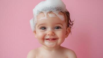 Radiant toddler gleefully bathes, her face adorned with fluffy soap bubbles against a soft pink backdrop, capturing pure childhood innocence. photo