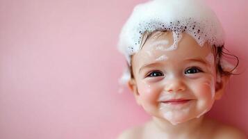 Adorable toddler smiles with sudsy bubbles on head during bath time against soft pink backdrop, innocence radiates from beautiful baby's eyes photo