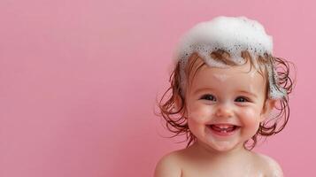 Adorable baby girl with a big smile, covered in bubbly soap suds during bath time, on a soft pink backdrop. Playful, clean, and happy moments. photo
