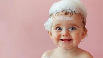 A delightful close-up of a smiling baby, covered in fluffy white soap bubbles against a soft pink backdrop, creating a heartwarming image. photo