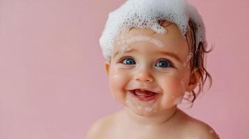 Joyful baby covered in bubbles smiles brightly against a soft pink backdrop, capturing a moment of pure, innocent happiness during bath time. photo