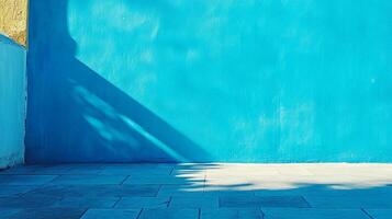 A vibrant turquoise wall basks in sunlight, casting shadows on the stone floor, creating a captivating play of color and light. photo