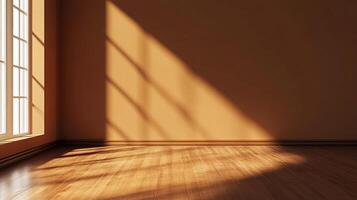 Sunlight streams through a window, casting shadows across the walls and hardwood floors of an otherwise empty room. Minimalist backdrop. photo