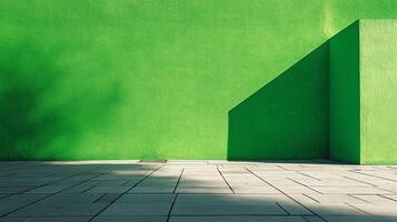 Minimalist architecture with a green wall corner casting shadows onto the concrete pavement, abstract design and light interplay. photo
