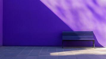 A purple bench sits against a vibrant wall, partially illuminated by sunlight creating dynamic shadows, blending serenity and abstraction. photo