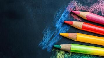 Colorful pencils with matching chalk strokes resting on a dark surface, a vibrant display of artistic tools and creative potential. photo