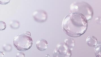A collection of translucent spheres float mid-air against a soft lavender background. The spheres vary in size, giving a sense of depth. photo