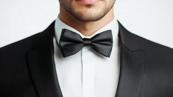 Elegant man in black suit and bowtie. Sharp dressed man. Sophistication and style personified. Formal attire and groomed appearance. Black tie event. photo