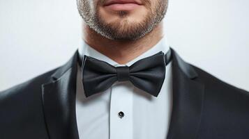 Man in black suit and bow tie, an elegant and refined look for formal occasions, professional attire, and special events. Stylish and classy. photo