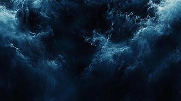 Abstract navy and white image. Evokes stormy ocean depths or celestial clouds. A dance of light and shadow creates depth and mystery. photo