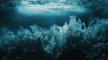 Underwater peaks rise into filtered sunlight, mysterious and awe-inspiring in the ocean's depths. A hidden world revealed beneath the surface. photo