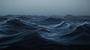 Moody ocean view with turbulent, dark blue waves rolling under a gray sky. Nature's power is on full display in this striking seascape. photo