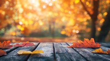 Autumn leaves rest on a rustic wooden surface, with a soft-focus background of vibrant fall foliage, creating a serene seasonal scene. photo