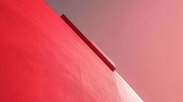A striking red wall is captured at an unusual angle, highlighting its texture and color depth, merging art and architecture in a compelling visual statement. photo