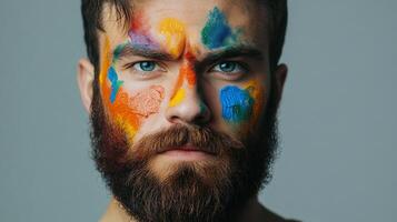 Man with face painted in vibrant colors, creating an artistic and expressive portrait, showcasing creativity and individuality. photo