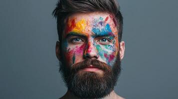 Man's face adorned with vibrant paint splatters, a striking blend of artistry and masculinity. Bold colors create a mesmerizing portrait. photo