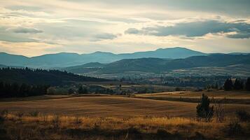 Picturesque landscape featuring rolling hills, distant mountains, and a dramatic sky, evoking a sense of serenity and natural beauty. photo