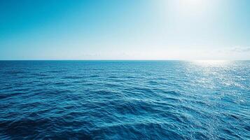 Blue seascape. A serene and calm ocean scene. Clear skies meet rippling waters, creating a tranquil, open horizon for a peaceful view. photo