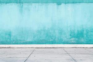 Aqua wall, light concrete floor, contrasting textures, simple composition, vibrant colors. Minimalist urban backdrop with plenty of copy space. photo