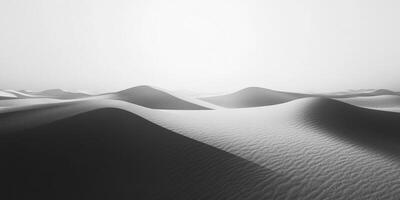 Serene desert landscape of undulating sand dunes. The monochrome palette emphasizes texture and form, creating a minimalist vista. photo
