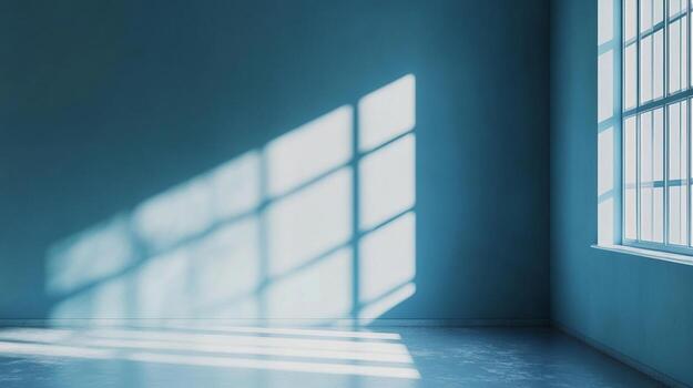 Sunlight streams through a paneled window casting a geometric pattern on a monochromatic blue wall and floor, creating a tranquil atmosphere. photo