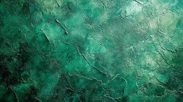 Abstract green textured background with a rough stone-like surface and a gradient of light to dark tones creating an interesting pattern. photo