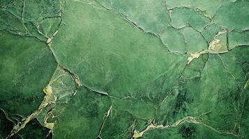 Green textured background featuring fractured pattern. Rich, dark green hues with lighter highlights accentuate the stone-like appearance. photo