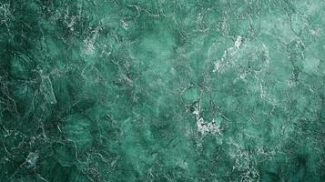 A dynamic green marble-like surface featuring swirling textures and subtle variations in tone, creating depth and visual interest. photo