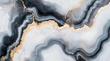 Elegant marble texture with fluid patterns of black, white, and gold, creating a sophisticated and luxurious abstract design. photo