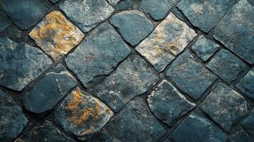 A textured surface of stone tiles. Each tile is unique in color and shape, creating a diverse visual appeal on this paved pathway. photo