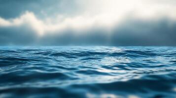Open water under a cloudy sky. Waves are softly forming as they crest the surface. This picture evokes peaceful contemplation. photo