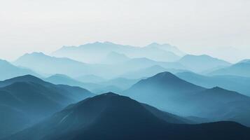 Layers of blue mountains receding into the distance, creating a serene and ethereal landscape, fading into a light sky. photo