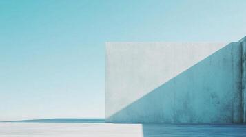 Minimalist architecture showcases a concrete wall bathed in sunlight against a clear sky, creating a serene, abstract composition. photo