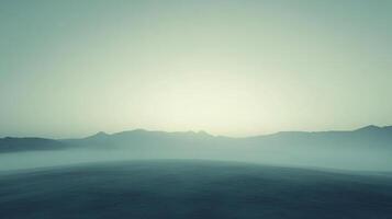 A serene landscape featuring rolling terrain shrouded in mist, with distant mountains and a gradient sky creating a peaceful atmosphere. photo