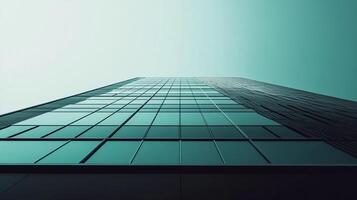 Abstract glass facade of high-rise building. Modern architecture with grid pattern of square windows against a sky of turquoise. photo